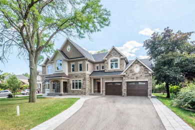 Large contemporary two-story brick house exterior idea in Toronto with a shingle roof