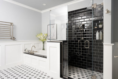 Inspiration for a large traditional ensuite bathroom in Boston with recessed-panel cabinets, white cabinets, a built-in bath, an alcove shower, a one-piece toilet, black tiles, ceramic tiles, grey walls, ceramic flooring, a submerged sink, engineered stone worktops, multi-coloured floors, a hinged door, black worktops, a wall niche, double sinks and a built in vanity unit.