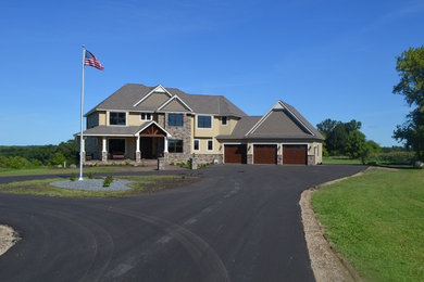 Huge elegant beige three-story mixed siding exterior home photo in Minneapolis with a shingle roof