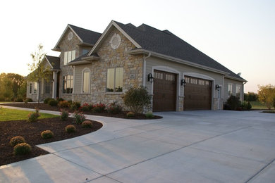 Example of a large classic beige two-story mixed siding house exterior design in Milwaukee with a hip roof and a shingle roof