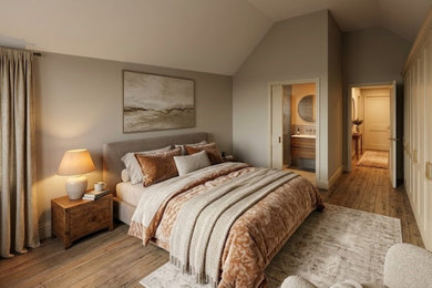 Photo of a master bedroom in Essex with beige walls, plywood flooring and brown floors.