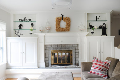 Mid-sized transitional open concept medium tone wood floor family room photo in Vancouver with gray walls, a two-sided fireplace, a stone fireplace and a media wall