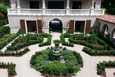 Inspiration for a large mediterranean courtyard full sun formal garden in Tampa with a garden path and gravel.