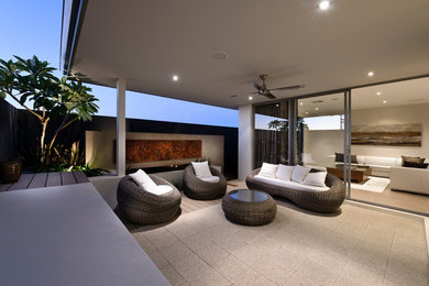 Design ideas for a modern backyard patio in Perth with a container garden, concrete pavers and a roof extension.