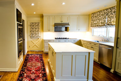 Large elegant l-shaped dark wood floor eat-in kitchen photo in Little Rock with an undermount sink, recessed-panel cabinets, white cabinets, marble countertops, white backsplash, stainless steel appliances and an island