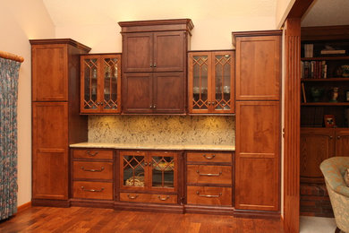 Open concept kitchen - mid-sized traditional single-wall dark wood floor open concept kitchen idea in Wichita with shaker cabinets, dark wood cabinets, granite countertops, beige backsplash and stone slab backsplash