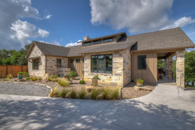 Inspiration for a mid-sized timeless one-story stone exterior home remodel in Austin with a shingle roof
