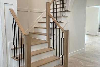 Inspiration for a mid-sized contemporary wooden l-shaped mixed material railing staircase remodel in New York with wooden risers