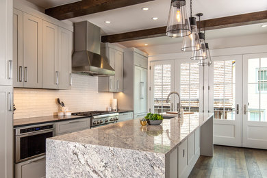 Open concept kitchen - contemporary single-wall open concept kitchen idea with shaker cabinets, gray cabinets, granite countertops, white backsplash, an island and gray countertops