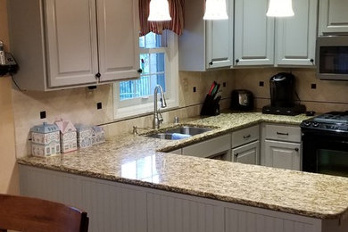 Eat-in kitchen - mid-sized traditional u-shaped concrete floor and brown floor eat-in kitchen idea in Louisville with a double-bowl sink, raised-panel cabinets, gray cabinets, granite countertops, beige backsplash, ceramic backsplash, stainless steel appliances and a peninsula