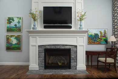 Living room - brown floor living room idea in Chicago with white walls, a standard fireplace, a brick fireplace and a wall-mounted tv