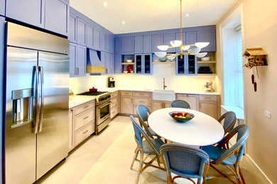 This is an example of a large classic l-shaped kitchen/diner in New York with shaker cabinets, blue cabinets, engineered stone countertops, no island and white worktops.