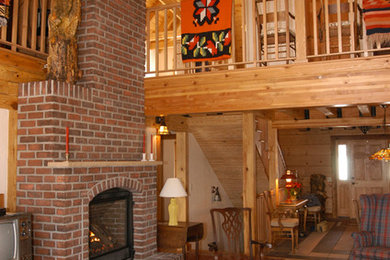 Large mountain style open concept medium tone wood floor and brown floor living room photo in Denver with a brick fireplace