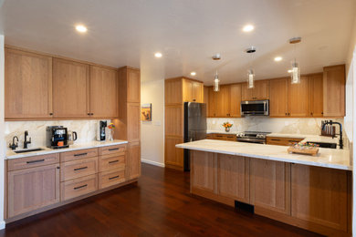 Inspiration for a mid-sized modern u-shaped dark wood floor and red floor eat-in kitchen remodel in San Francisco with an undermount sink, shaker cabinets, medium tone wood cabinets, quartz countertops, white backsplash, quartz backsplash, stainless steel appliances, a peninsula and white countertops