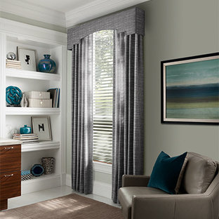 Large modern home office and library in Denver with yellow walls, medium hardwood flooring and a freestanding desk.