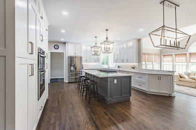 Eat-in kitchen - large contemporary galley medium tone wood floor and brown floor eat-in kitchen idea in DC Metro with a single-bowl sink, white cabinets, quartz countertops, white backsplash, marble backsplash, stainless steel appliances, an island and white countertops