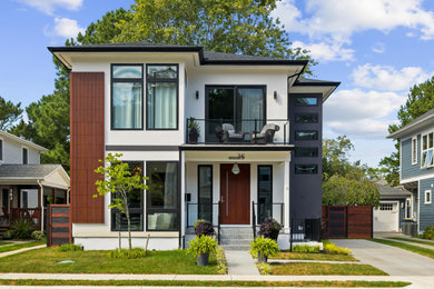 Inspiration for a large contemporary white two-story mixed siding exterior home remodel in Other with a shingle roof and a black roof