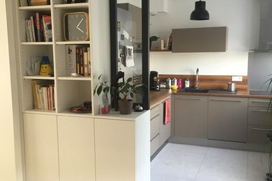 This is an example of a mid-sized contemporary kitchen/dining combo in Angers with white walls, ceramic floors and no fireplace.