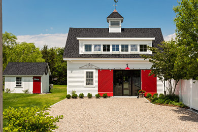 Inspiration for a country freestanding desk dark wood floor home studio remodel in Boston with white walls