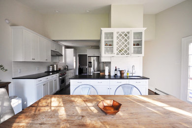 Kitchen/dining room combo - mid-sized transitional medium tone wood floor and brown floor kitchen/dining room combo idea in Richmond with gray walls and no fireplace