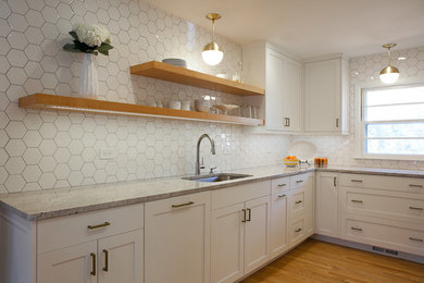 Inspiration for a small transitional u-shaped light wood floor eat-in kitchen remodel in Atlanta with an undermount sink, shaker cabinets, white cabinets, granite countertops, white backsplash, ceramic backsplash, stainless steel appliances and no island
