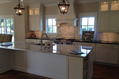 Inspiration for a kitchen remodel in Other with an undermount sink, marble countertops, white backsplash and an island