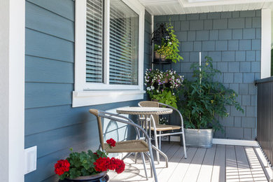 Inspiration for a mid-sized arts and crafts front yard verandah with a container garden, decking and a roof extension.