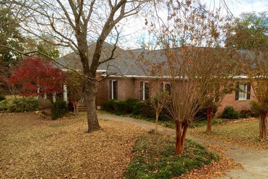 Inspiration for a large craftsman white one-story brick exterior home remodel in Other with a hip roof