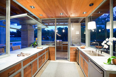 Open concept kitchen - mid-sized contemporary galley concrete floor open concept kitchen idea in Austin with a double-bowl sink, flat-panel cabinets, medium tone wood cabinets, concrete countertops, stainless steel appliances and an island