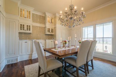 Inspiration for a mid-sized transitional dark wood floor enclosed dining room remodel in Louisville with yellow walls