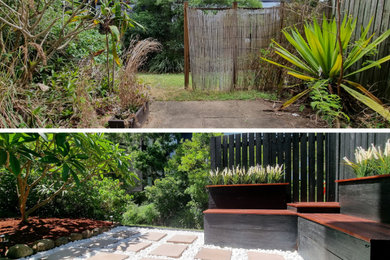 Inspiration for a small and australian native tropical courtyard partial sun garden in Brisbane with decking and a wood fence.