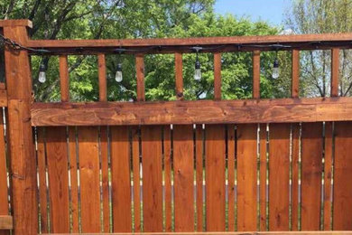 This is an example of a large modern privacy backyard wood fence landscaping in Other.
