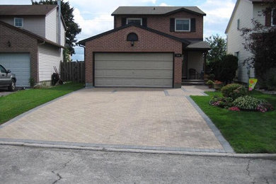 Photo of a mid-sized traditional full sun front yard stone landscaping in Toronto.