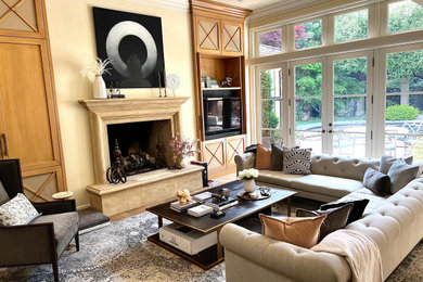 This is an example of a transitional living room in San Francisco with a concrete fireplace surround.