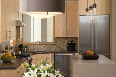 Mid-sized trendy l-shaped porcelain tile and beige floor eat-in kitchen photo in Portland with an undermount sink, flat-panel cabinets, light wood cabinets, concrete countertops, multicolored backsplash, mosaic tile backsplash, stainless steel appliances and an island