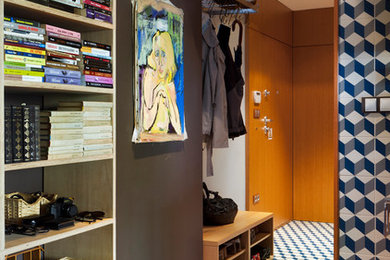 Inspiration for a small modern ceramic tile entryway remodel in Other with a medium wood front door