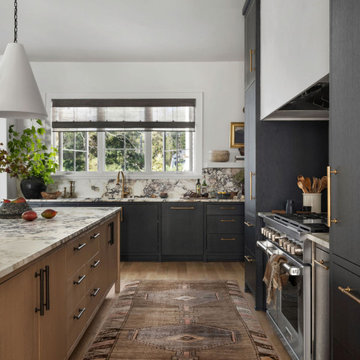 Moody Custom Kitchen with Black Cabinets, Marble Backsplash & Brass Hardware