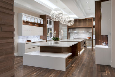 Inspiration for a contemporary l-shaped separate kitchen in Calgary with an undermount sink, flat-panel cabinets, white cabinets, quartzite benchtops, multi-coloured splashback, matchstick tile splashback, stainless steel appliances, dark hardwood floors and with island.
