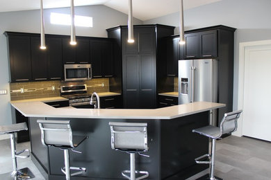 Inspiration for a large contemporary l-shaped vinyl floor and gray floor open concept kitchen remodel in Chicago with an undermount sink, flat-panel cabinets, black cabinets, quartz countertops, multicolored backsplash, glass tile backsplash, stainless steel appliances and an island