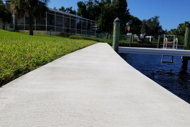 Dock - large coastal backyard dock idea in Tampa with no cover