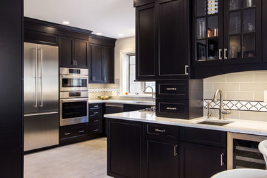 Inspiration for a large contemporary l-shaped enclosed kitchen remodel in Philadelphia with an undermount sink, recessed-panel cabinets, black cabinets, quartzite countertops, multicolored backsplash, ceramic backsplash, stainless steel appliances and no island