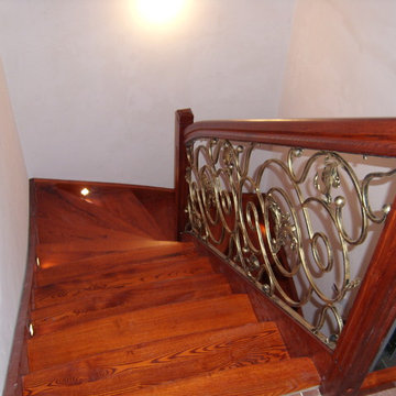Holztreppe mit schmiedeeisernen Elementen in der Ballustrade (Handlauf)