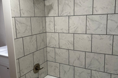 Example of a small classic multicolored tile and ceramic tile vinyl floor, brown floor and single-sink bathroom design in Other with shaker cabinets, gray cabinets, a one-piece toilet, gray walls, an undermount sink, solid surface countertops, white countertops and a freestanding vanity
