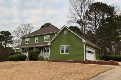 Photo of a large traditional three-storey green house exterior in Atlanta with concrete fiberboard siding.