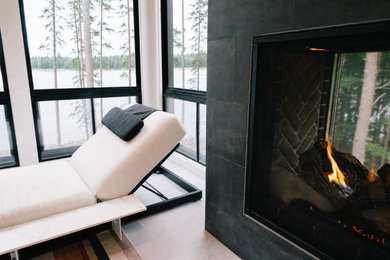 Mid-sized minimalist tile glass railing front porch idea in Portland Maine with a fireplace and a roof extension