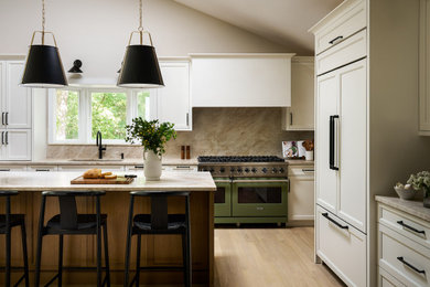 Inspiration for a large transitional kitchen remodel in Chicago with white cabinets, quartzite countertops, stone slab backsplash and an island