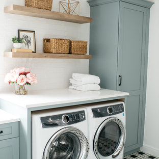 Country single-wall separated utility room in Detroit with shaker cabinets, blue cabinets, white walls, a side by side washer and dryer, multi-coloured floors and white worktops.