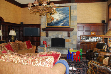 Example of a mid-sized classic enclosed dark wood floor and brown floor living room design in San Diego with a bar, beige walls, a standard fireplace, a stone fireplace and a wall-mounted tv