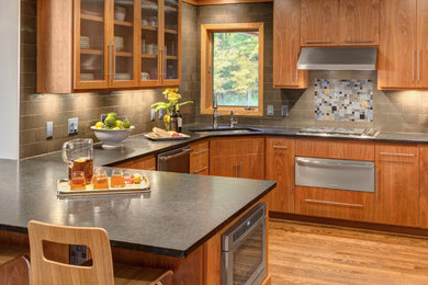 Mid-sized minimalist u-shaped medium tone wood floor eat-in kitchen photo in Minneapolis with an undermount sink, flat-panel cabinets, granite countertops and no island