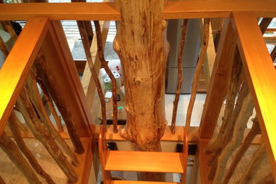 Example of a mid-sized mountain style wooden straight open staircase design in Vancouver